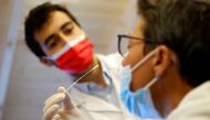 A medical worker administers a nasal swab to a patient at a coronavirus disease (COVID-19) testing centre in Nantes, near Nantes, France, June 30, 2022. REUTERS/Stephane Mahe

