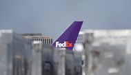 The tail fin of a cargo aircraft with FedEx livery is seen among air freight containers at a FedEx regional hub at Los Angeles International Airport (LAX) in Los Angeles, California, US, on September 16, 2022. (REUTERS/Bing Guan)