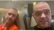 British Prisoners of war (POWs) sit in a flight following their release from Russian captivity after fighting for Ukraine, amid Russia's attack on Ukraine, in this screen grab of a video obtained from social media. Instagram/cossackgundi/via Reuters 