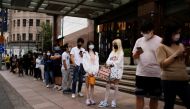 People line up to get tested for the coronavirus disease (Covid-19) at a nucleic acid testing site on a street, following the Covid-19 outbreak, in Shanghai, China, on September 21, 2022. (REUTERS/Aly Song)