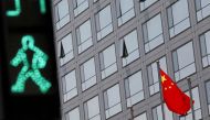 A Chinese national flag flutters outside the China Securities Regulatory Commission (CSRC) building on the Financial Street in Beijing on July 9, 2021. File Photo / Reuters
