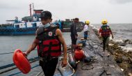 Volunteers and local officials patrol the neighbourhood to remind residents to evacuate, in preparation for Super Typhoon Noru, in Manila, Philippines, September 25, 2022. REUTERS/Lisa Marie David
