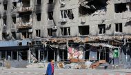 A local resident walks past an apartment block damaged in the course of Russia-Ukraine conflict in Mariupol, Ukraine September 25, 2022. Reuters/Alexander Ermochenko