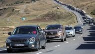 Travellers from Russia drive after crossing the border to Georgia at the at the Zemo Larsi/Verkhny Lars station, Georgia, on September 26, 2022. (REUTERS/Irakli Gedenidze)