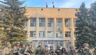 Ukrainian troops pose for a photo in Lyman, Ukraine in this picture released in social media October 1, 2022. Courtesy of Oleksiy Biloshytskyi/via Reuters