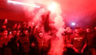 Football club supporters light a red flare during a vigil at Patriot Candrabhaga Stadium, after a riot and stampede at Kanjuruhan Stadium following a soccer match between Arema vs Persebaya Surabaya, in Bekasi, on the outskirts of Jakarta, Indonesia, on October 3, 2022. (REUTERS/Ajeng Dinar Ulfiana)