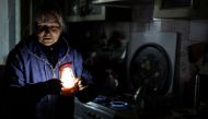 Olga Kobzar stands in her kitchen as she shows how she heats her house by gas stove cooktop, as Russia's attack on Ukraine continues, in her apartment in Saltivka neighbourhood of Kharkiv, Ukraine, September 22, 2022. REUTERS/Umit Bektas