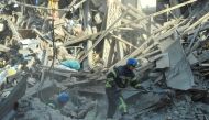 Rescuers work at the site of a residential building heavily damaged by a Russian missile strike, amid their attack on Ukraine, in Zaporizhzhia, Ukraine October 6, 2022. REUTERS/Stringer