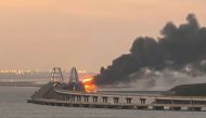 A view shows a fire on the Kerch bridge at sunrise in the Kerch Strait, Crimea, October 8, 2022. Reuters/Stringer