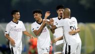 Al Sadd's Baghdad Bounedjah celebrates with team-mates.