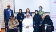 Officials and members from Commercial Bank and Qatar Society for Rehabilitation of Special Needs in Doha recently. 