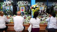 People pray at Wat Si Uthai temple following a mass shooting in the town of Uthai Sawan, Nong Bua Lam Phu province, Thailand October 10, 2022. REUTERS/Athit Perawongmetha
