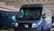 A new Amazon EV van powered by Rivian is driven past spectators at the Amazon Logistics Facility in Chicago, Illinois, US, July 21, 2022. (REUTERS/Jim Vondruska)