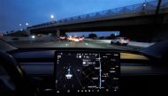 A Tesla Model 3 vehicle drives on autopilot along the 405 highway in Westminster, California, US, on March 16, 2022. (REUTERS/Mike Blake)

