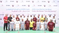 Officials and participants from QNB and QSCCB, during the “Goalball for the Blind” tournament, recently. 