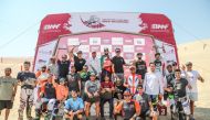 The podium winners of bike events pose for a photograph with officials of Qatar Motor and Motorcycle Federation after the conclusion of the fifth round of 2022 Qatar Off Road Championship.