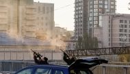 Police officers shoot at a drone during a Russian drone strike, which local authorities consider to be Iranian-made Shahed-136 unmanned aerial vehicles (UAVs), amid Russia's attack on Ukraine, in Kyiv, Ukraine, on October 17, 2022. REUTERS/Vadim Sarakhan