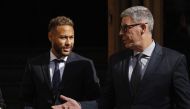 Brazil's Neymar leaves court with a member of his lawyer team after standing trial on fraud and corruption charges over the transfer to FC Barcelona from Santos in 2013, in Barcelona, Spain, October 18, 2022. (REUTERS/Albert Gea)