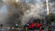 Firefighters help a local woman evacuate from a residential building destroyed by a Russian drone strike, which local authorities consider to be Iranian-made unmanned aerial vehicles (UAVs) Shahed-136, amid Russia's attack on Ukraine, in Kiev, Ukraine, on October 17, 2022. REUTERS/Vladyslav Musiienko