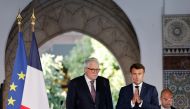 French President Emmanuel Macron joins hands before giving the highest French order of merit Legion of Honor (Legion d'Honneur) to Rector of Paris' Grand Mosque Chems-Eddine Hafiz, during a visit for the commemorative century exposition of the opening of the Grande Mosque of Paris, in Paris, France, on October 19, 2022.  Ludovic MARIN/Pool via REUTERS