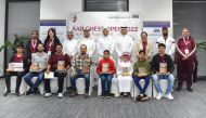 The trophy winning players pose for a picture with officials after the conclusion of AAB Chess Open.  