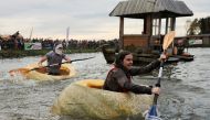 Contestants compete during the Pumpkin Regatta, an annual pumpkin boat relay race, in the Belgian town of Kasterlee, Belgium October 23, 2022. REUTERS/Bart Biesemans