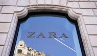 A building is reflected in the window of a Zara clothes store, part of the Spanish Inditex group, in Bilbao, Spain, November 30, 2021. (REUTERS/Vincent West)