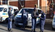 File Photo: Members of the South African Police Services (SAPS) stand guard outside the High Court. (Guillem Sartorio/AFP)