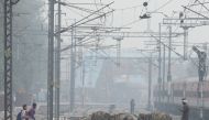 File Photo: School girls and mules are seen crossing railway tracks on a smoggy morning in New Delhi, India, December 2, 2021. (REUTERS/Anushree Fadnavis)