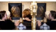 Visitors are reflected in a mirror as they look at The Creation of Jesus on the Cross by Rembrandt on display at Museum Bredius in The Hague on November 3, 2022. (Koen van Weel / AFP)