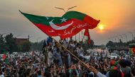 Supporters of former Pakistani prime minister Imran Khan, take part in a protest as they block the main road a day after the assassination attempt on Khan, in Peshawar, on November 4, 2022. (AFP/Abdul MAJEED)