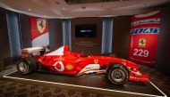 This photograph taken on November 4, 2022, shows F1 World Champion Michael Schumacher's Formula One Ferrari F2003 GA with chassis number 229 during Sotheby's auction house preview in Geneva. (AFP/Fabrice Coffrini)