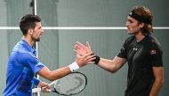 Serbia's Novak Djokovic (left) shakes hands with Greece's Stefanos Tsitsipas after winning at the end of their men's singles semi-final tennis match on day 6 of the ATP World Tour Masters 1000 - Paris Masters (Paris Bercy) - indoor tennis tournament at The AccorHotels Arena in Paris on November 5, 2022. (Photo by Christophe ARCHAMBAULT / AFP)