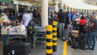 Passengers wait in a queue at the Jomo Kenyatta International airport, to re-book their flights after flights were cancelled, amid a strike by pilots organised by Kenya Airline Pilots Association (KALPA), at the Jomo Kenyatta International airport in Nairobi on November 5, 2022. (AFP/Simon Maina)