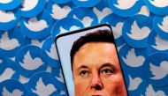 An image of Elon Musk is seen on a smartphone placed on printed Twitter logos in this picture illustration taken April 28, 2022. File Photo / Reuters