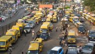 Vehicles drive in chaotic traffic gridlock past yellow painted mini buses, popularly called Danfo, parked at Ojodu-Berger bus station in Lagos, Nigeria's commercial capital, on October 19, 2022. (Photo by PIUS UTOMI EKPEI / AFP)