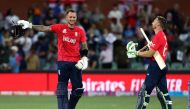 England's Captain Jos Buttler (R) and Alex Hales celebrate their win after the ICC men's Twenty20 World Cup 2022 semi-final cricket match between England and India at The Adelaide Oval on November 10, 2022 in Adelaide. Photo by Surjeet Yadav / AFP