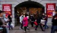 People walk along a main shopping area during the Alibaba's Singles' Day shopping festival in Shanghai, China November 11, 2021. REUTERS/Aly Song/File Photo