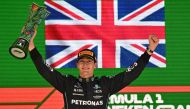 Mercedes' British driver George Russell celebrates in the podium after winning the Formula One Brazil Grand Prix, at the Autodromo Jose Carlos Pace racetrack, also known as Interlagos, in Sao Paulo, Brazil, on November 13, 2022. (Photo by NELSON ALMEIDA / AFP)
