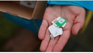 A local employee of Ukrainian telecom provider Kyivstar shows a handful of Russian SIM cards discarded by local residents after they switched to Ukrainian SIM cards in Kherson, Ukraine, on November 17, 2022. REUTERS/Joseph Campbell