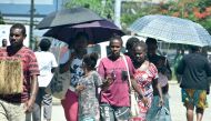 Families walk outside the hospital building in downtown of Honiara on November 22, 2022, as people rushed from their offices and fleeing to higher ground after a strong earthquake. Photo by Mavis PODOKOLO / AFP

