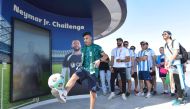 Fans participating in football activities at Lusail stadium.