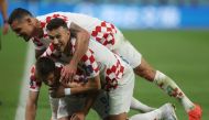 Croatia's Andrej Kramaric celebrates scoring their third goal of the FIFA World Cup Qatar 2022 Group F match against Canada with teammates Ivan Perisic and Dejan Lovren at the Khalifa International Stadium, Doha, Qatar, on November 27, 2022.  REUTERS/Paul Childs