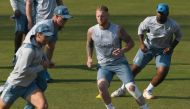 England captain Ben Stokes (2R) warms during a training session.  Photo by Aamir QURESHI / AFP)