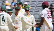 West Indies' batsman Jayden Seales (R) shakes hands with Australia's Steve Smith (C) after Australia won the first Test cricket match against the West Indies at Perth Stadium on December 4, 2022. (Photo by Trevor Collens / AFP)