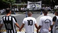 Fans hold hands during a vigil in front of the Albert Einstein Hospital where Brazilian football legend Pele is hospitalized in Sao Paulo, Brazil, December 4, 2022. (REUTERS/Carla Carniel)