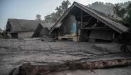 This picture shows damaged houses inundated by mud following a volcanic eruption by Mount Semeru at Kajar Kuning village in Lumajang on December 5, 2022. Photo by JUNI KRISWANTO / AFP