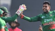 Bangladesh's Mehidy Hasan Miraz (R) celebrates with teammates after the dismissal of Indian's Shikhar Dhawan (unseen) on December 4, 2022. (Photo by Munir uz Zaman / AFP)