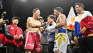 Manny Pacquiao (centre R) of the Philippines and DK Yoo (centre L) of South Korea react after their exhibition boxing match in Goyang, northwest of Seoul, on December 11, 2022. (Photo by Jung Yeon-je / AFP)