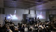 Officials of ispace Inc's HAKUTO-R mission look at live broadcasting of the launch of a SpaceX Falcon 9 rocket for ispace at Cape Canaveral Space Force Station, in Tokyo, Japan December 11, 2022. Kyodo via Reuters
